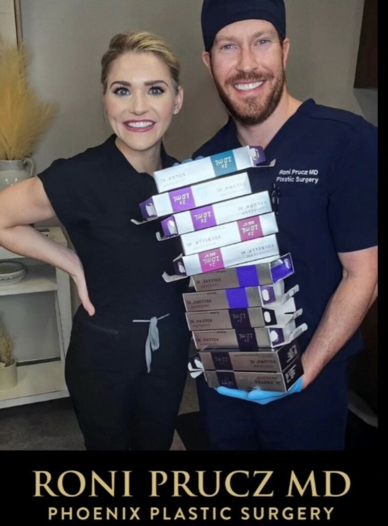 Dr. Prucz holding multiple filler boxes after Promotional Filler Day Phoenix Arizona
