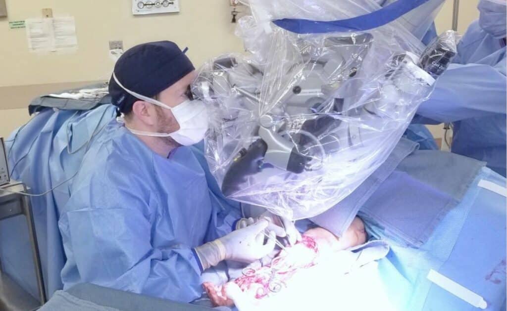 Roni Prucz MD Top Rated Phoenix Plastic Surgeon Using a Microscope During Microsurgery